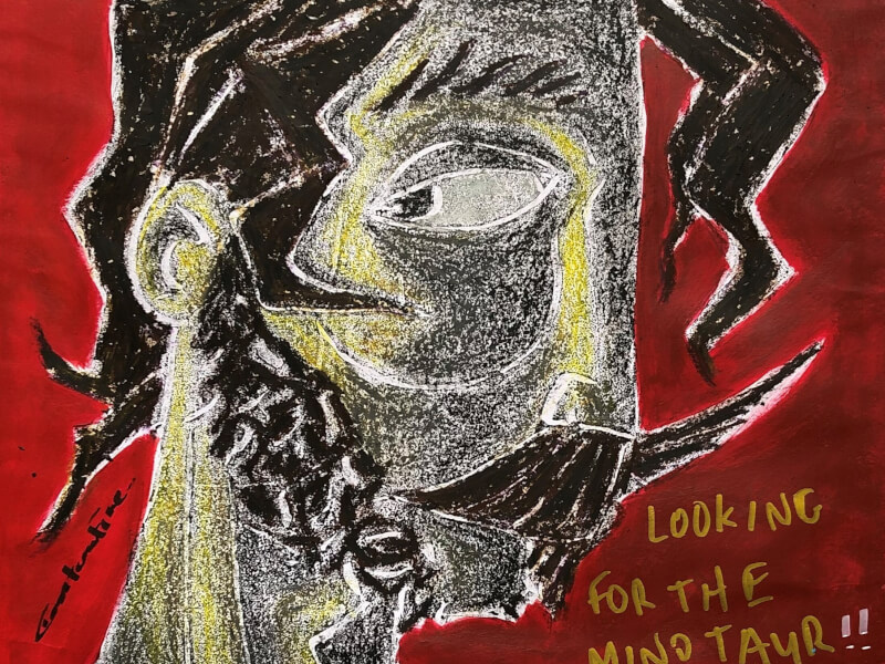 A handmade print of a face in red, yellow and black ink